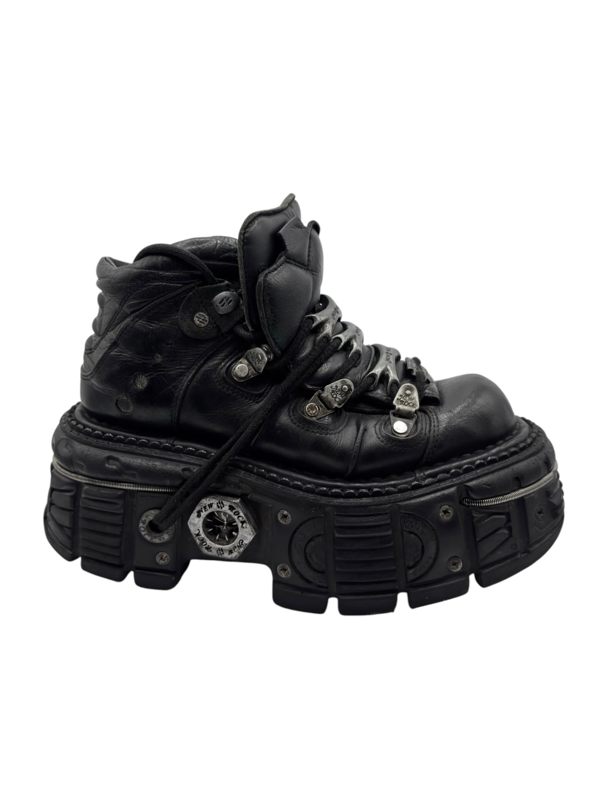 Black platform ankle boots with laces, layered straps, and treaded sole detail.