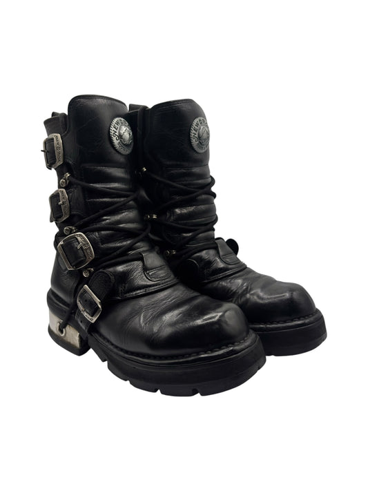 Black mid-calf lace-up leather boots with side buckles and sculpted raised sole