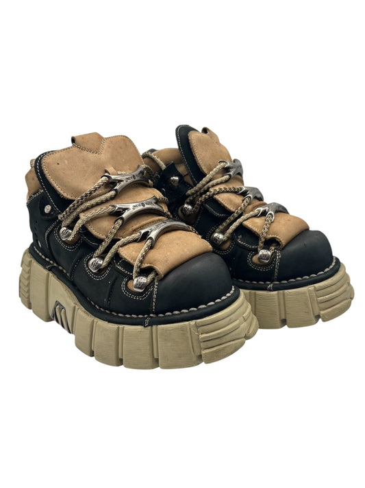 Pair of dark blue platform boots with tan panels, lace-up front, and rugged sole