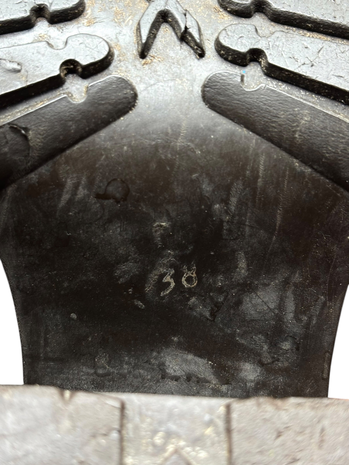 Rubber outsole bottom with embossed tread pattern and raised markings