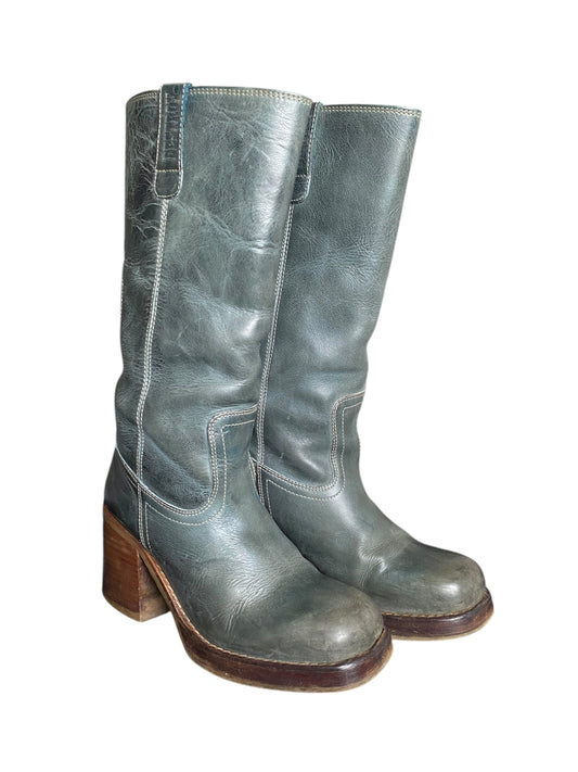 Angle view of jade green leather mid-calf boots with buckle strap and block heel