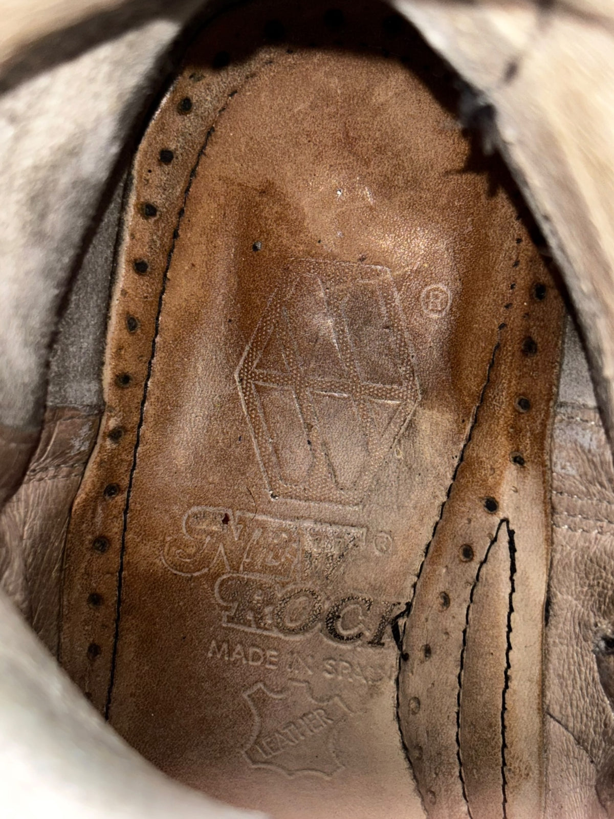 Raised heel ankle boot insole with embossed branding and stitching detail