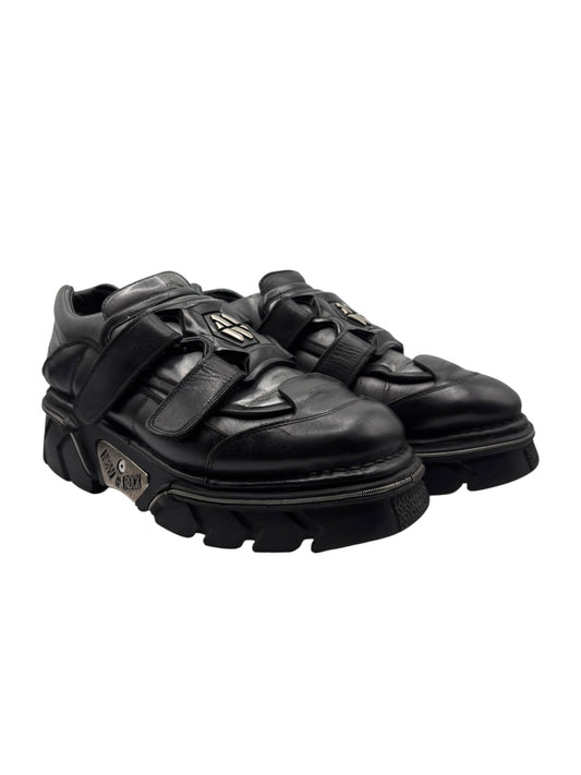 Black platform boots angled side view with thick lug sole and straps