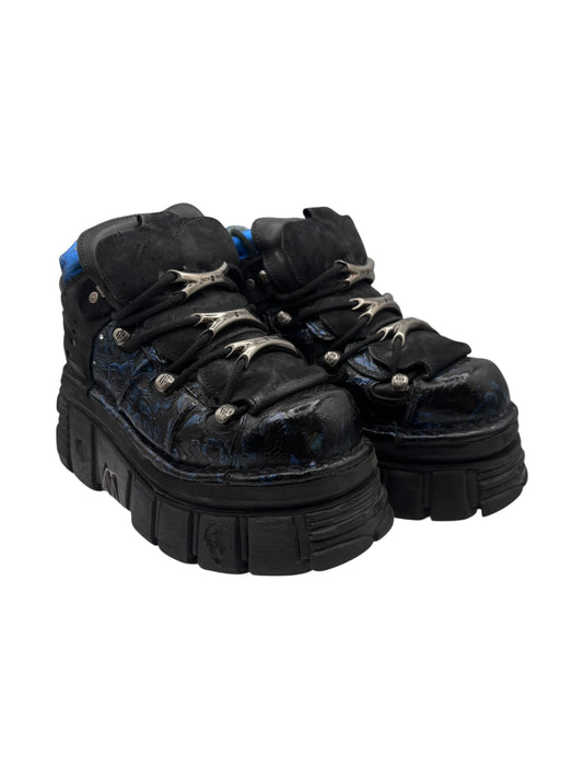 Dark lace-up platform boots with blue patterning and silver eyelets, thick lug sole