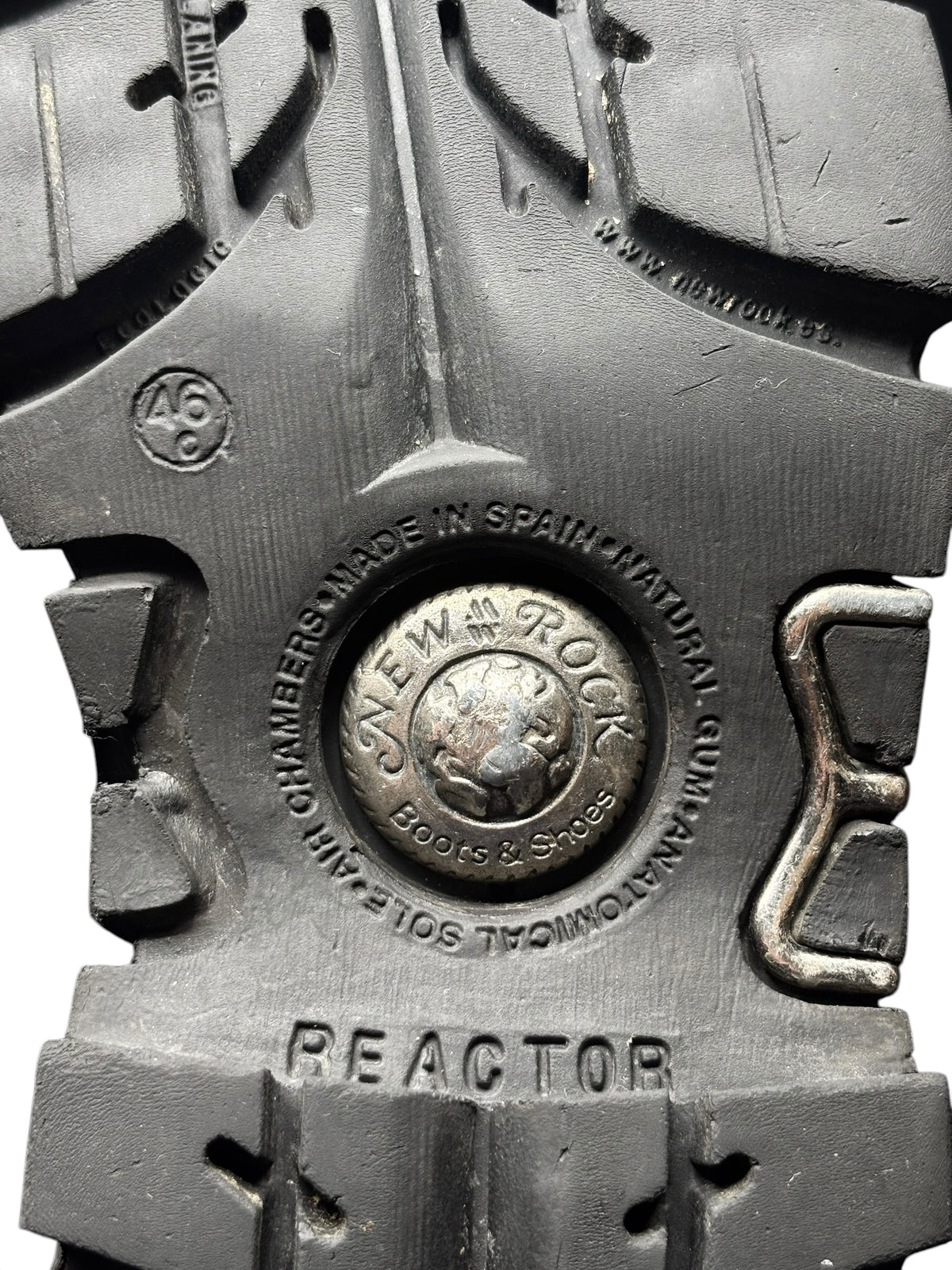 Leather boot insole with circular stamp and “REACTOR” text on metal plate