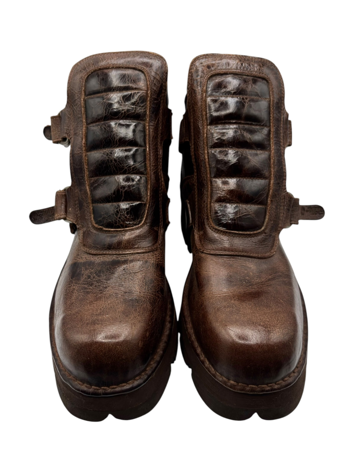 Brown distressed leather ankle boots with padded panels and chunky lug soles