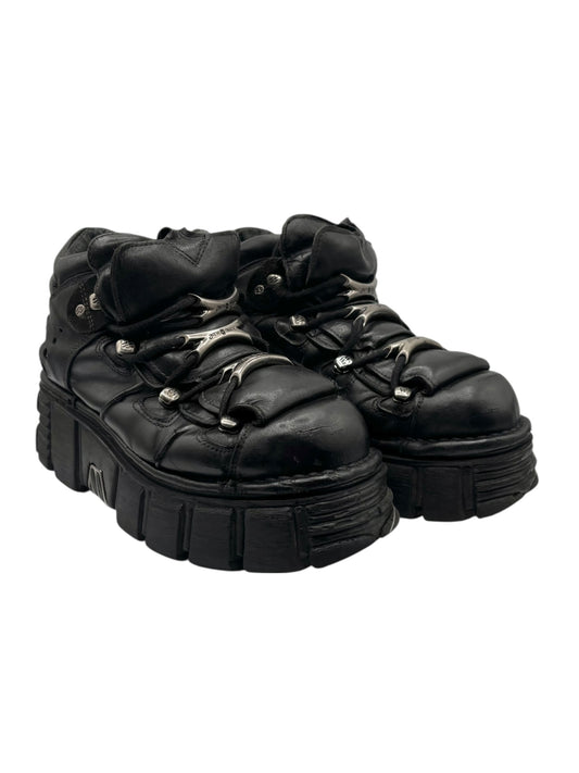 Black platform lace-up boots with stitched leather panels and thick chunky sole