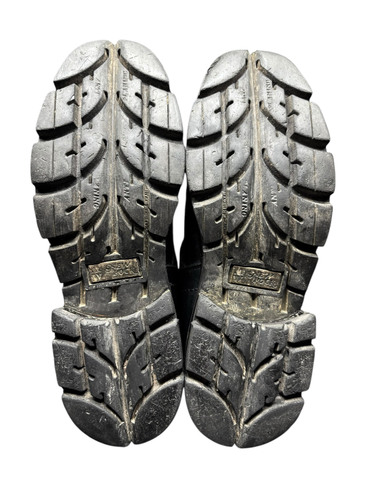 Pair of black buckled boots with thick ridged rubber soles