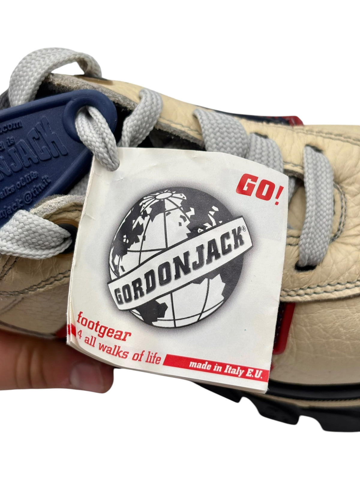 Beige sneaker tongue with GORDONJACK label and red "GO!" tag