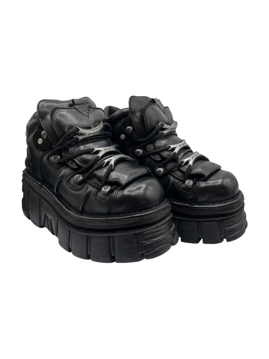 Pair of black New Rock platform boots, angled side view with thick rubber sole
