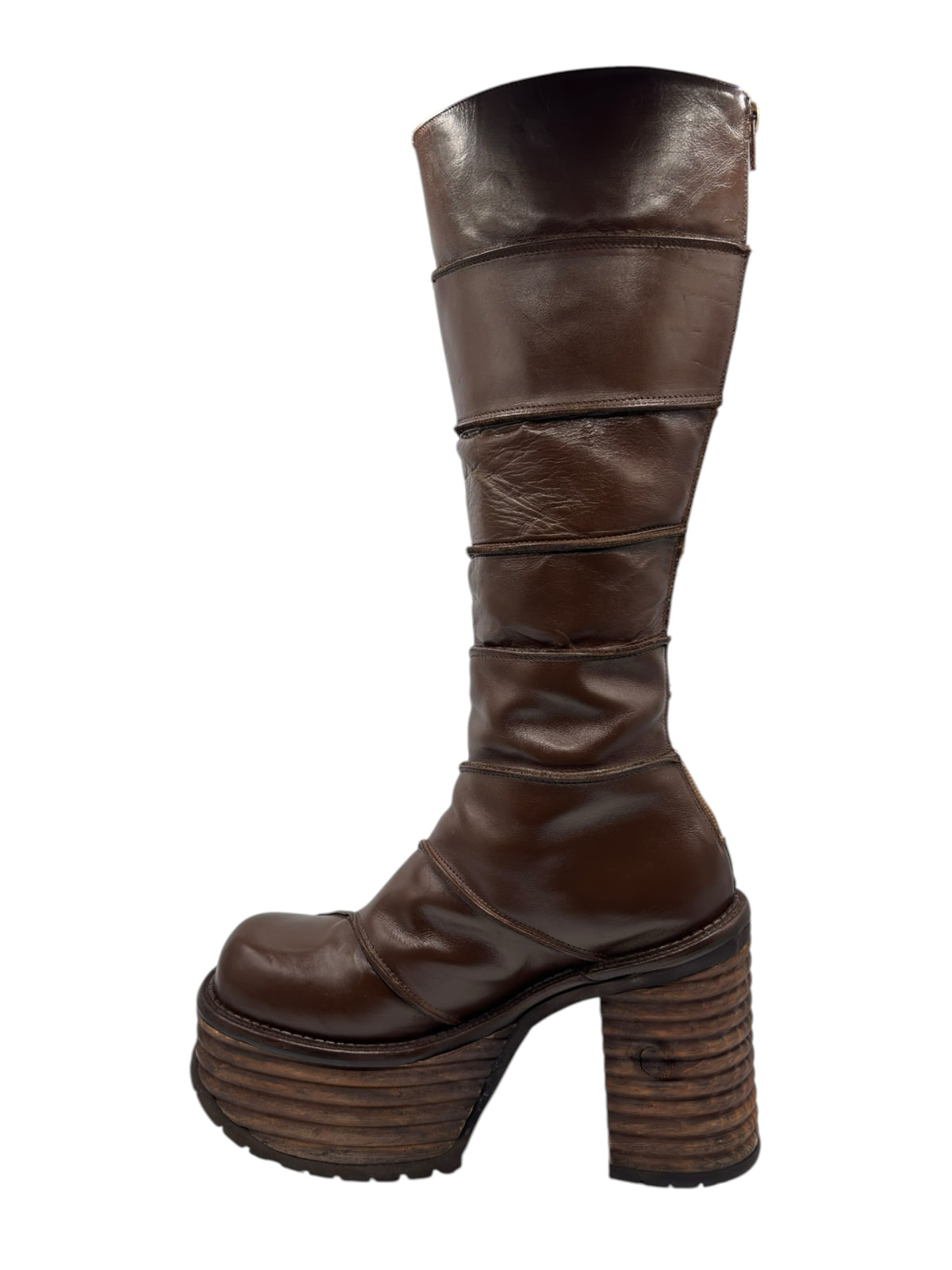 Brown knee-high platform boots with wide straps across shaft and chunky stacked sole