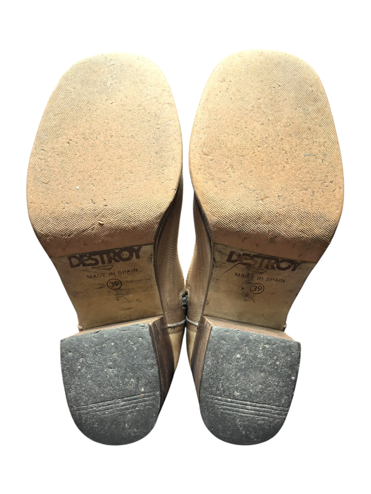 Beige knee-high leather boots soles, marked DESTROY on footbed and rubber heel.