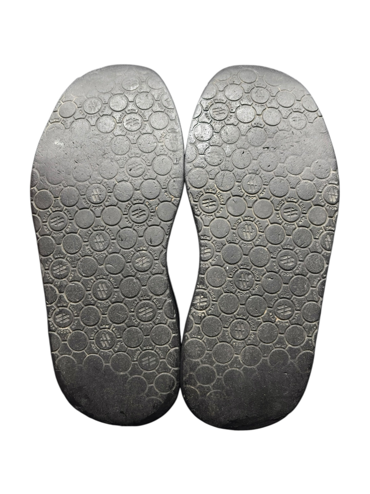 Pair of dark rubber platform boot outsoles with circular tread pattern