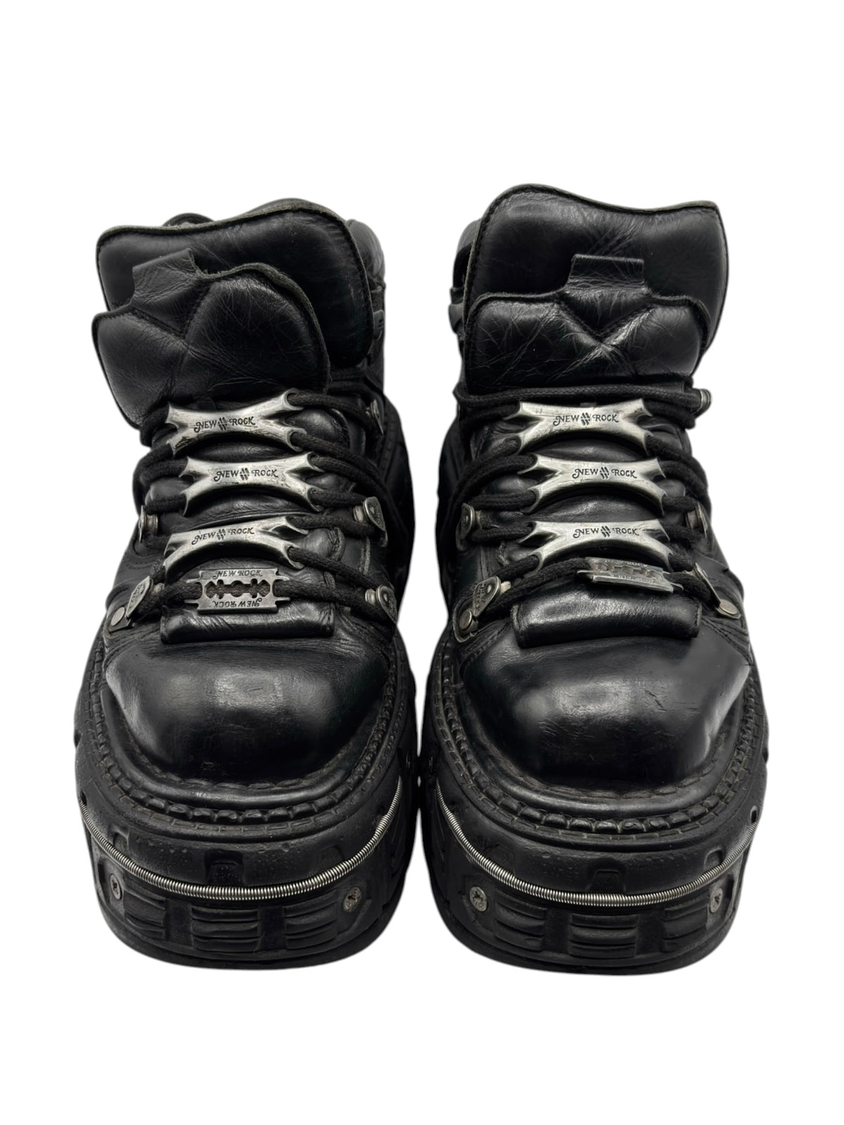 Black platform boots front view with lace-up closure and textured sole.