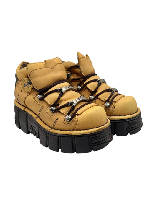 Mustard-yellow lace-up platform boots shown at a slight angle with thick black sole.