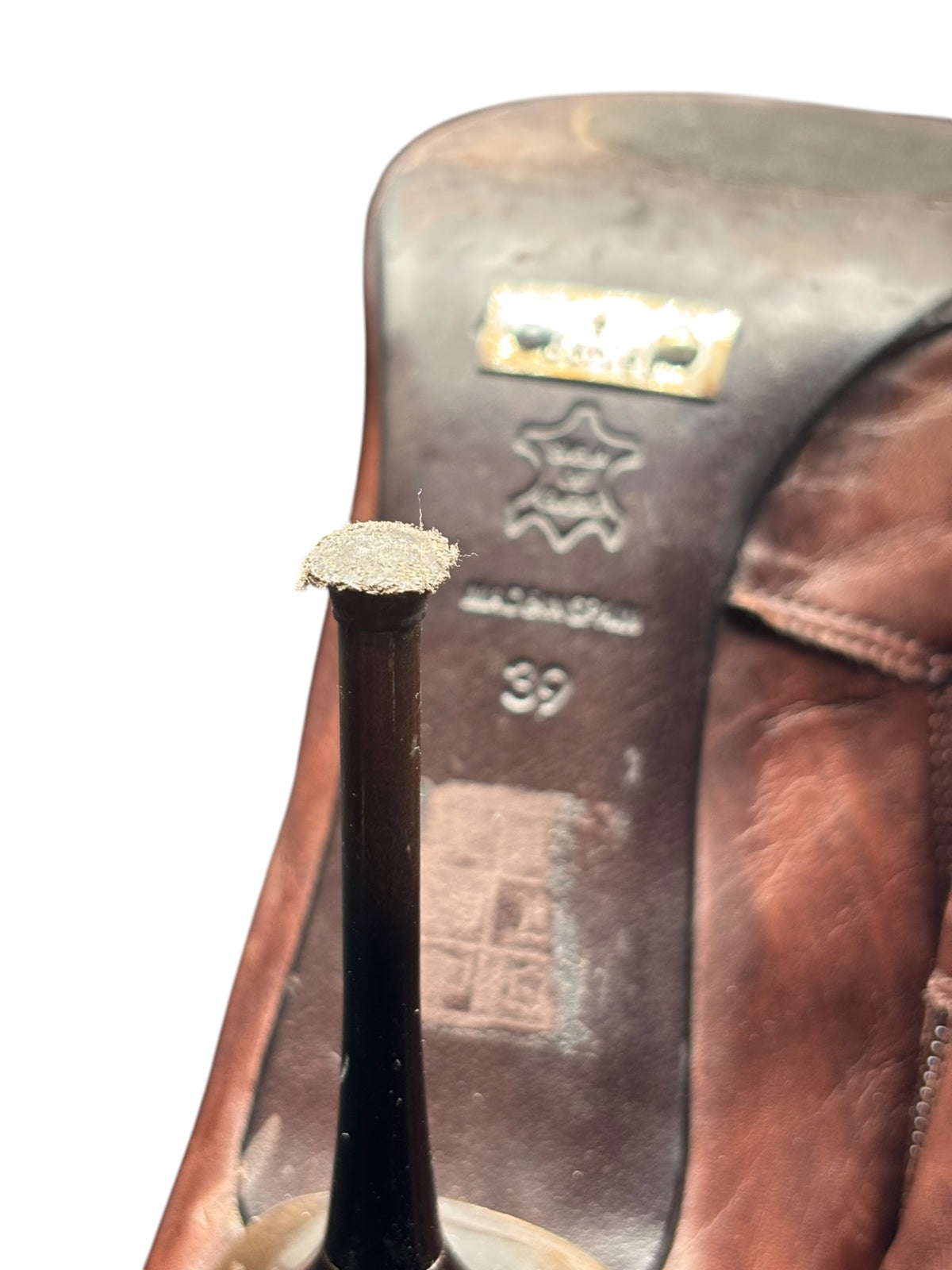 Boot interior close-up with metal label, star icon, and size 39