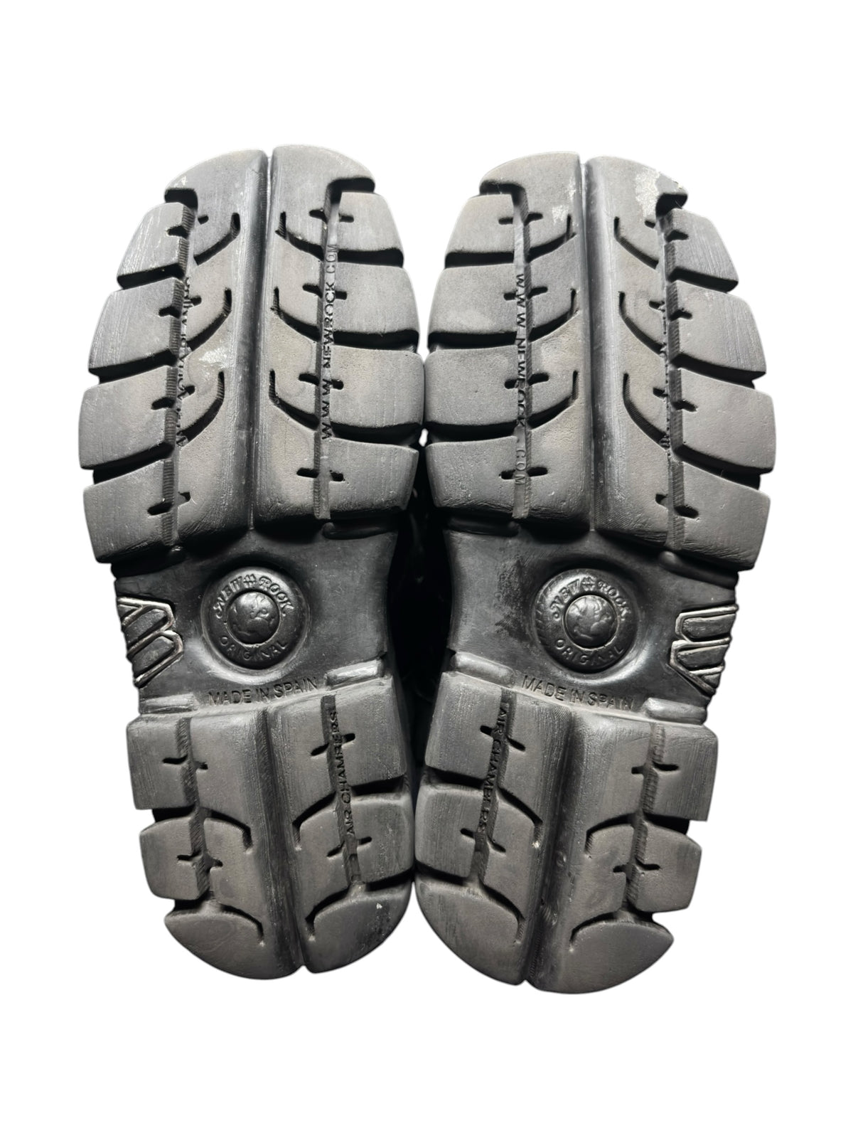 Pair of black platform boot soles with tread pattern and round logo