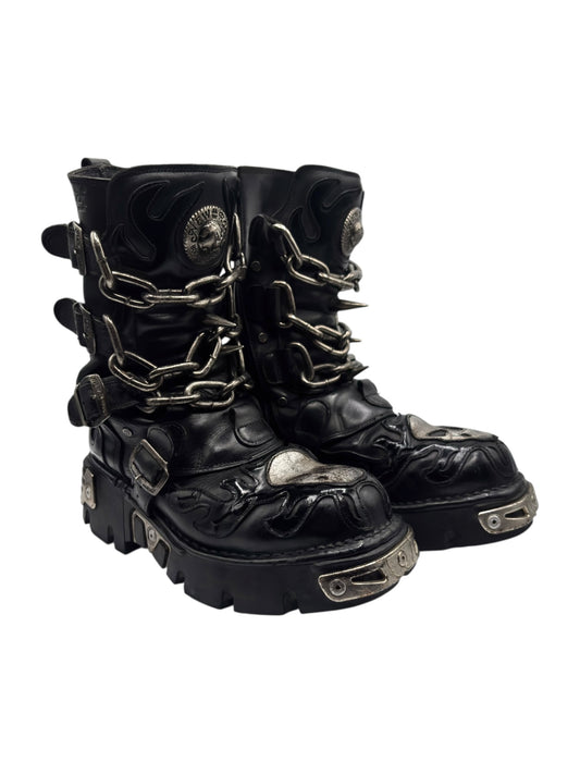 Black leather biker-style ankle boots with chain straps, skull patch, and chunky metal-sole