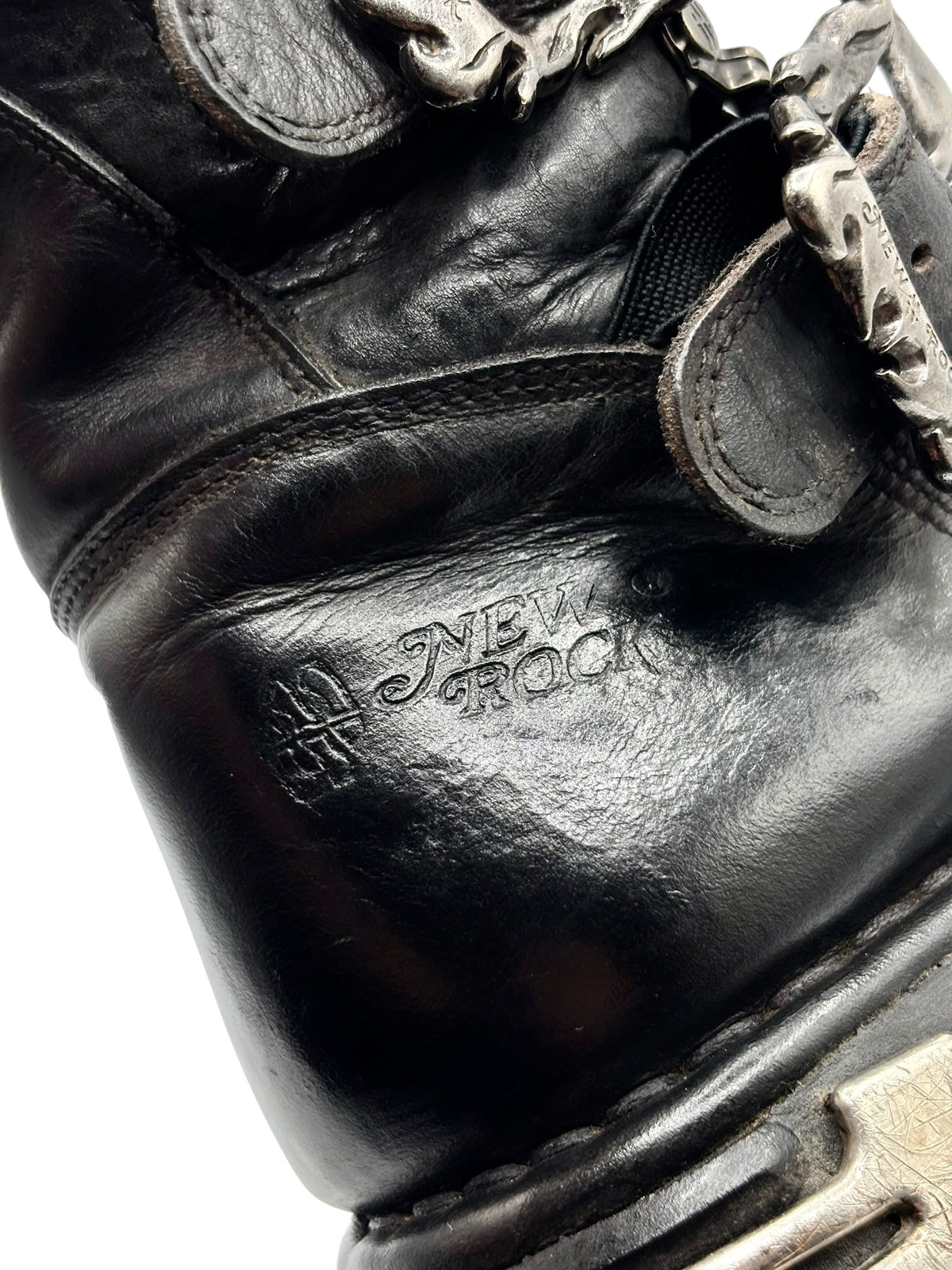 Close-up of black leather boot upper with stitched strap and NEW ROCK branding