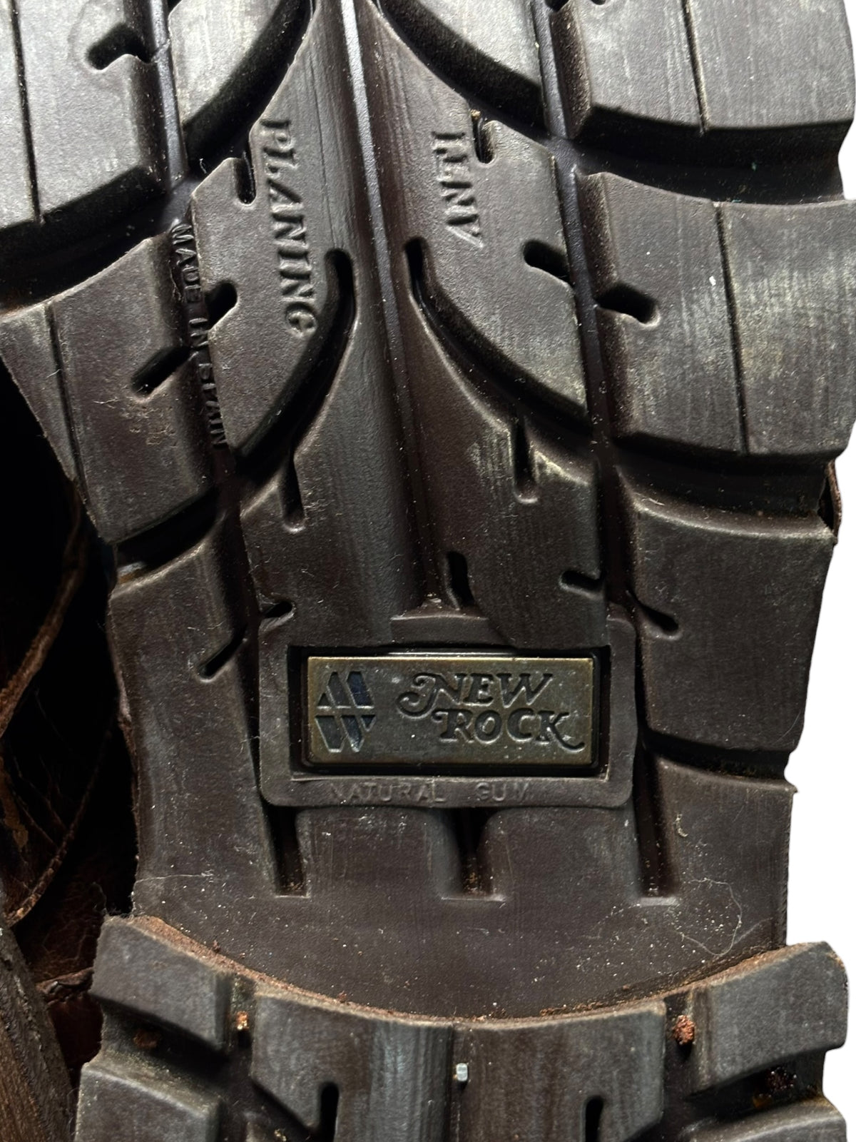 Brown leather boot outsole with chunky tread and New Rock logo plate