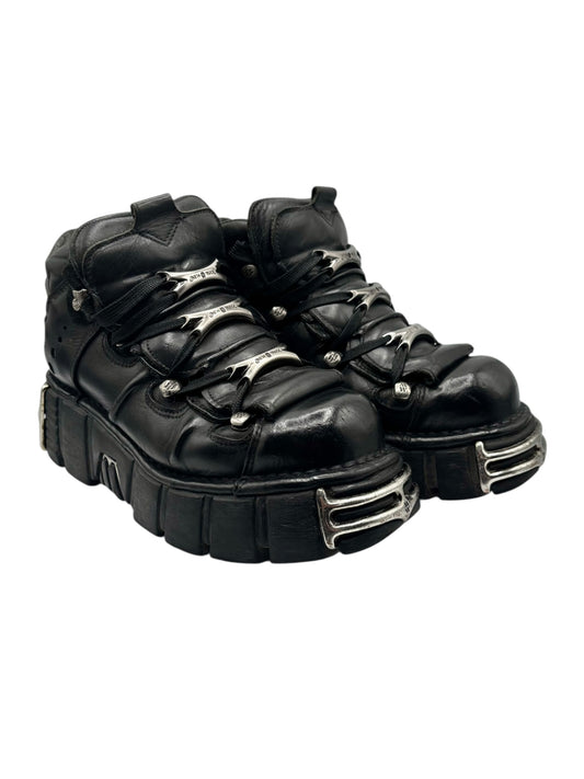 Black platform boots with silver buckles and lace-up front, chunky sole
