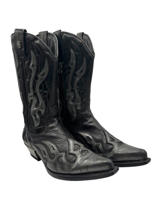 Vintage cowboy boots in dark leather with flame-stitched accents and angled low heels.