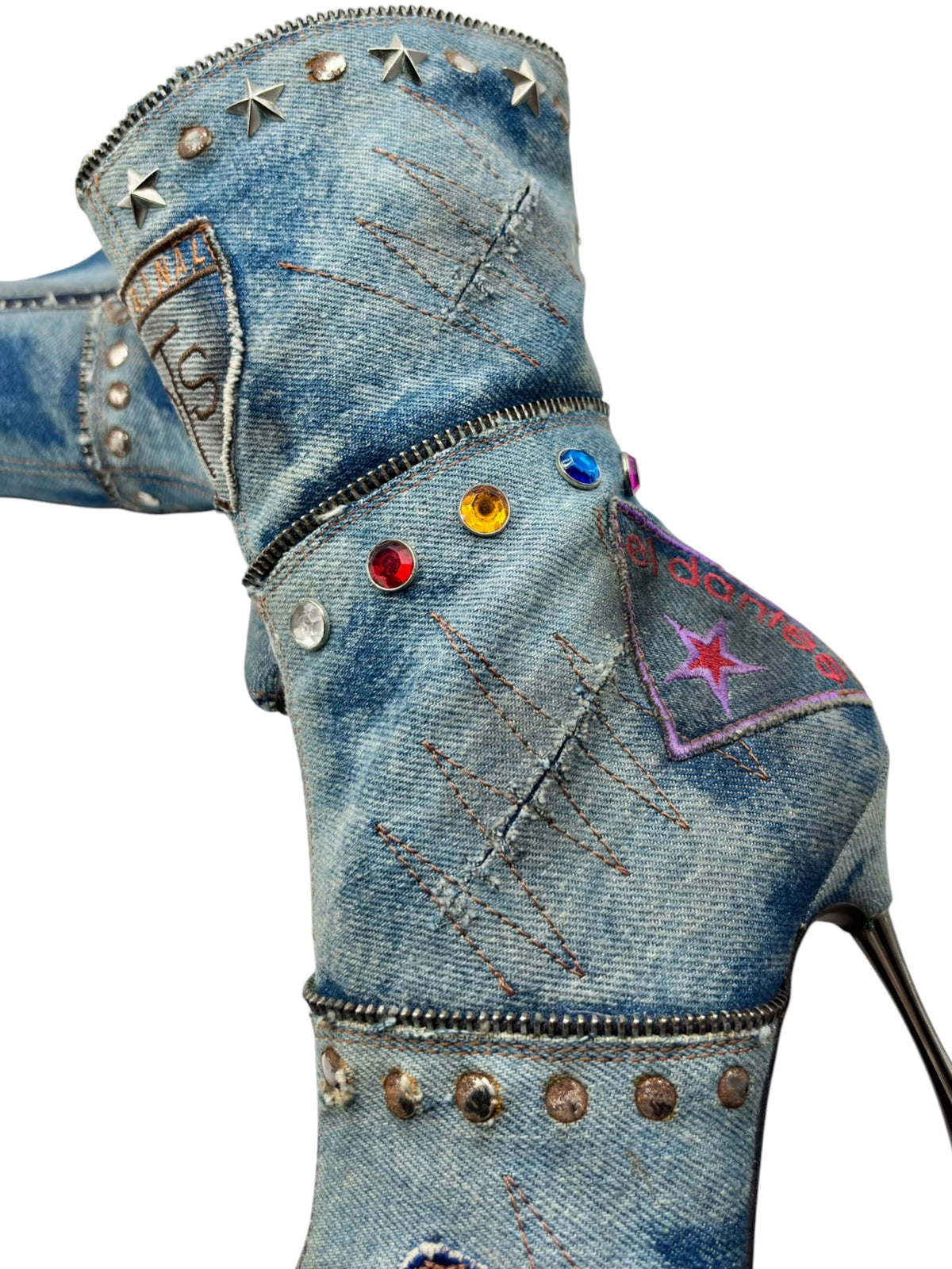 Denim boot upper side with star studs, colorful beads, and stiletto heel.