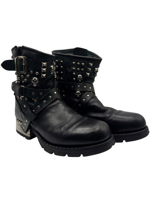 Black studded leather biker boots, side profile with buckle strap and metal spike accents