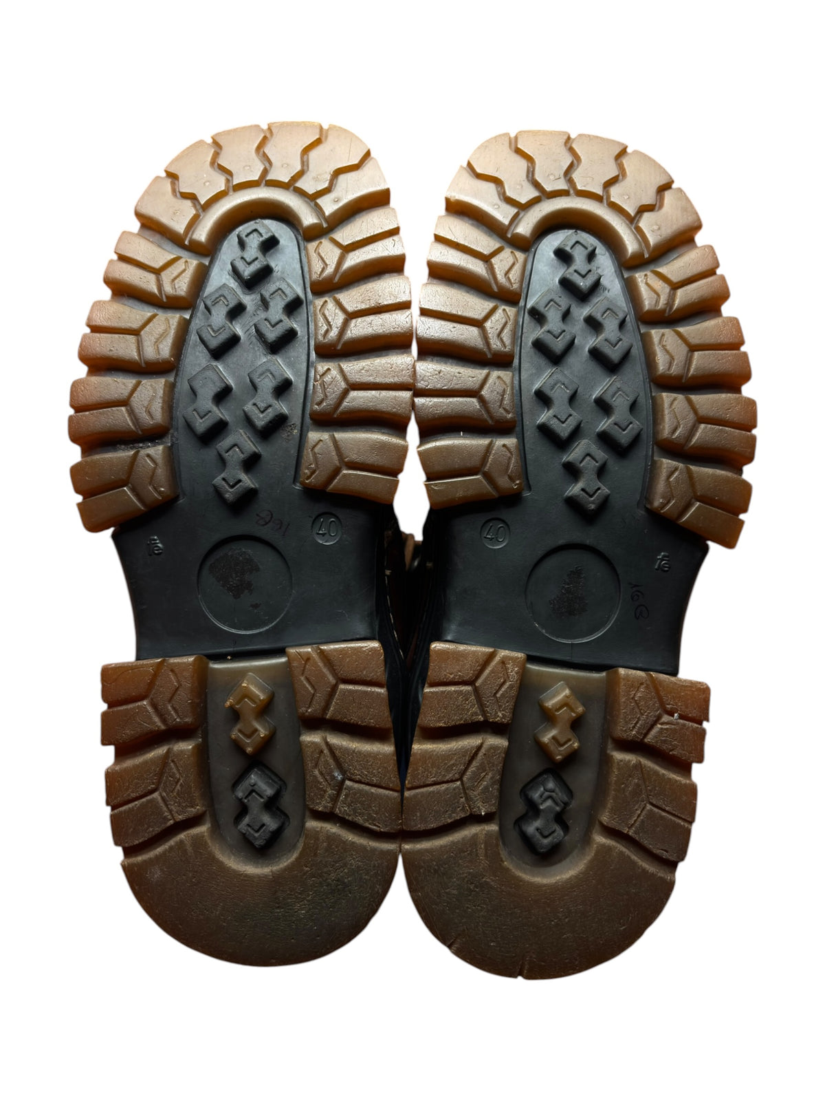Pair of boot outsoles with chunky lug tread and central traction panel