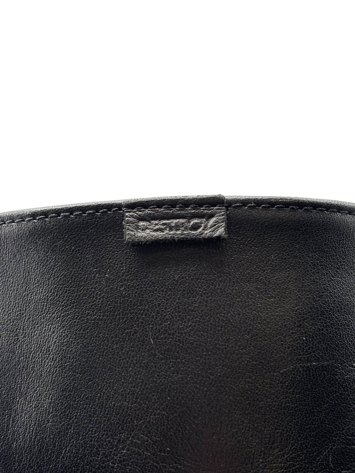 Black leather knee-high boots with stitched top cuff and small fabric pull tab.