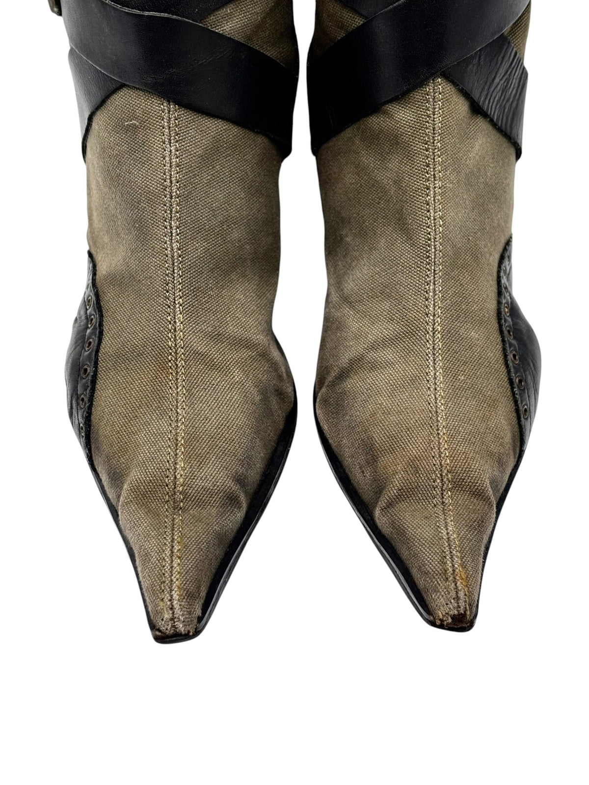 Olive pointed boots with black ankle straps and stitched detail at toe