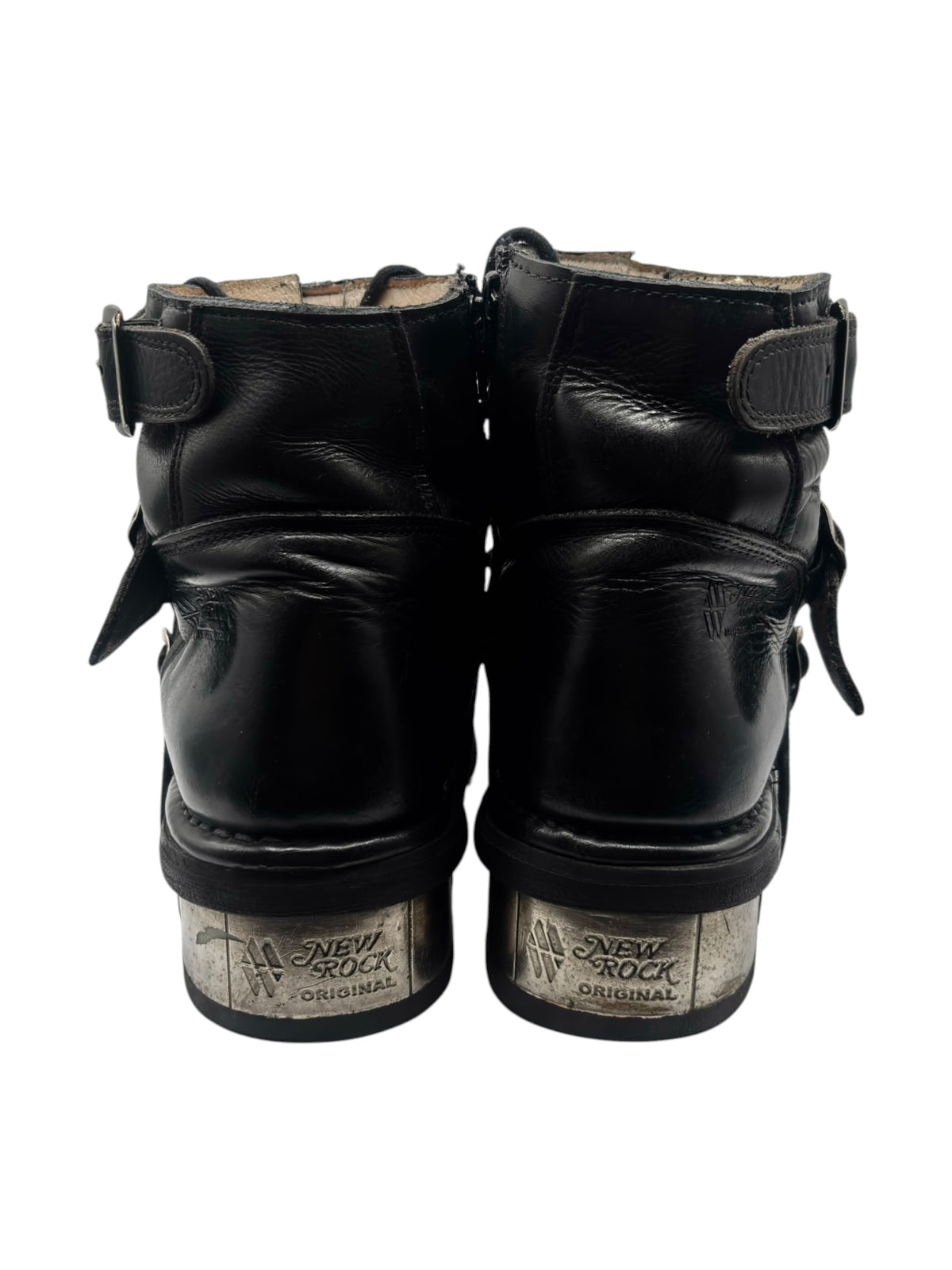 Back view of black raised heel ankle boot with ankle straps and embossed heel label
