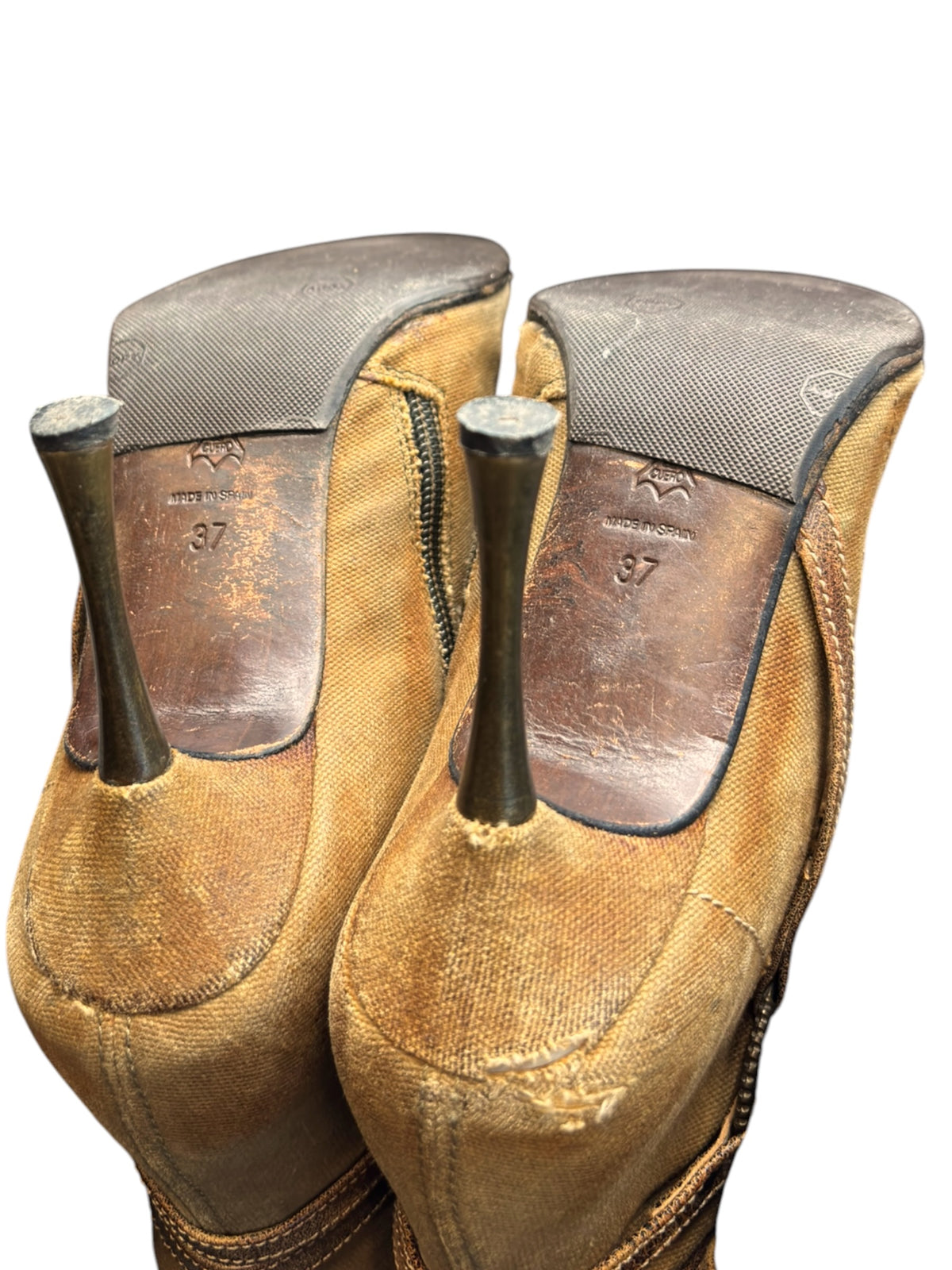 Pair of tan knee-high boots with dark gray insoles and heel counter