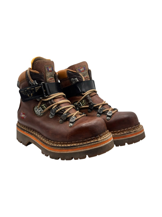 Brown leather lace-up ankle boots with black straps and chunky lug soles