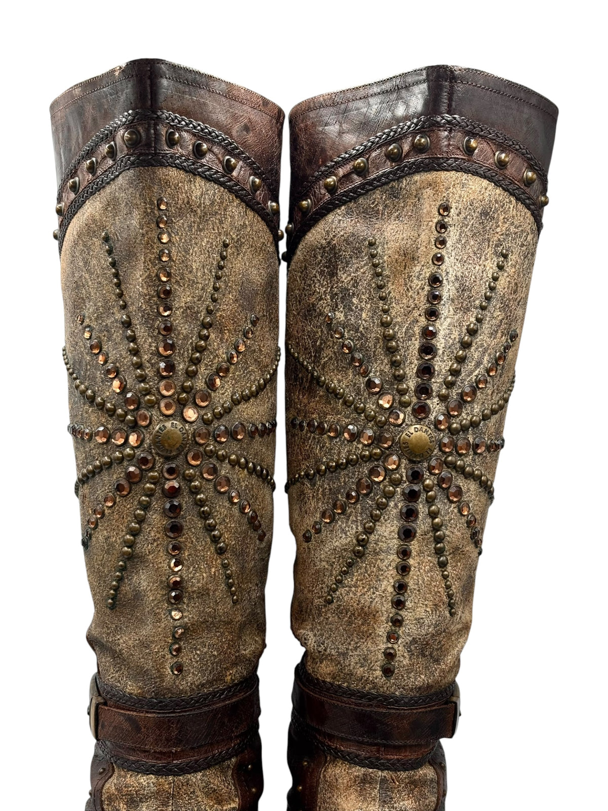 Pair of knee-high boots front view with studded medallion pattern and rounded toe