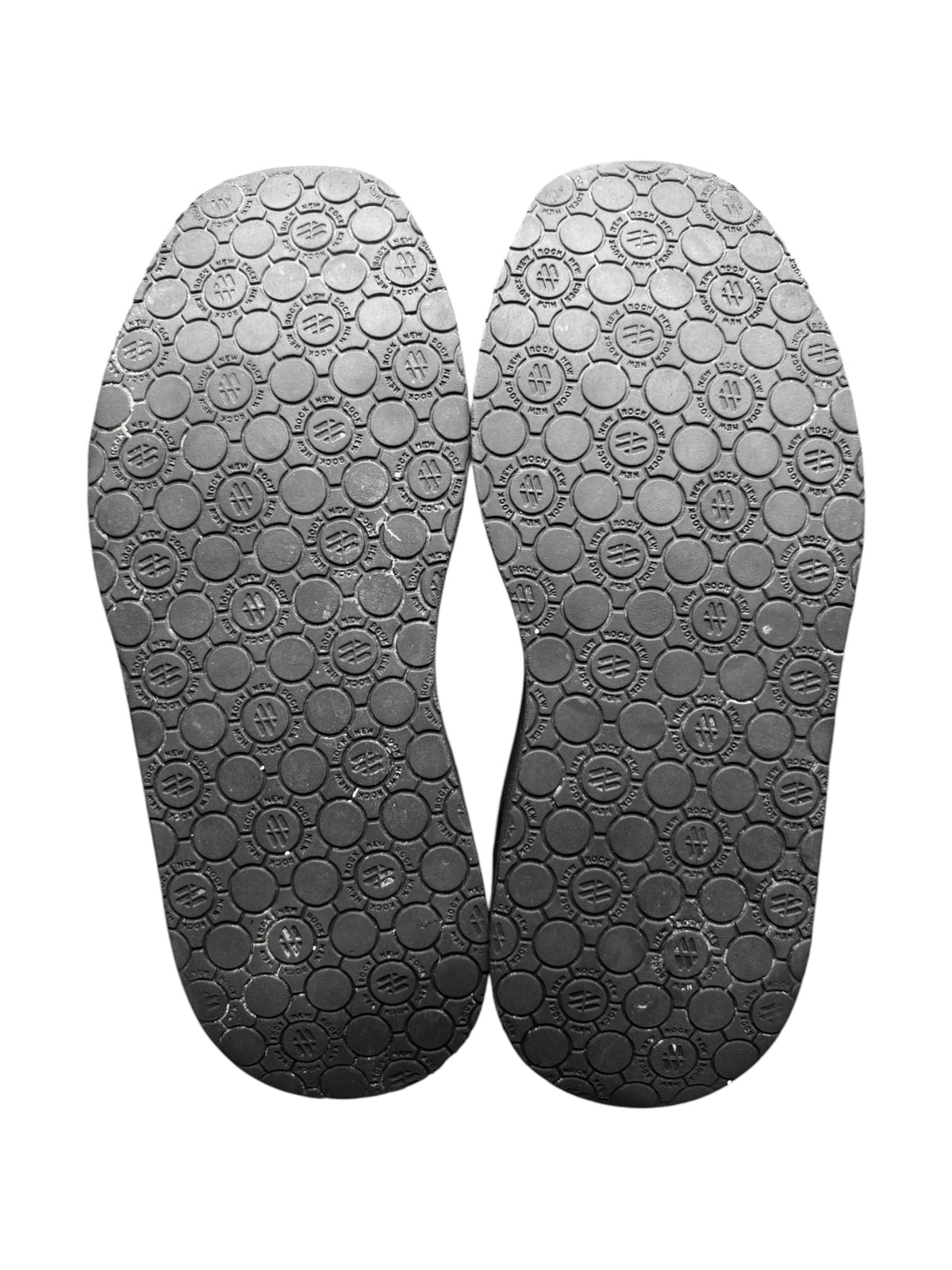 Pair of dark platform boot soles with circular tread texture