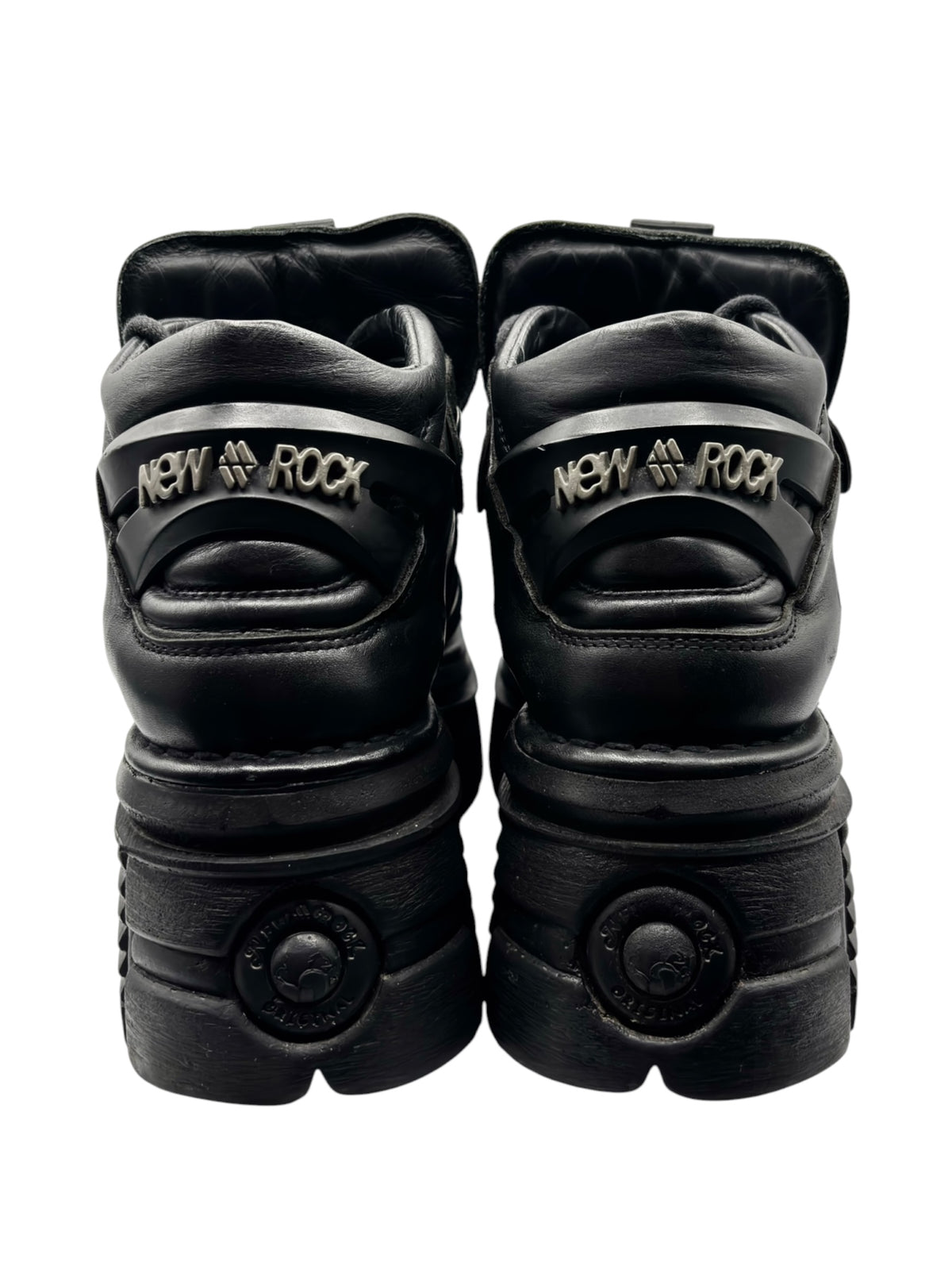 Black platform boots back view with “New Rock” strap detail and round heel logo